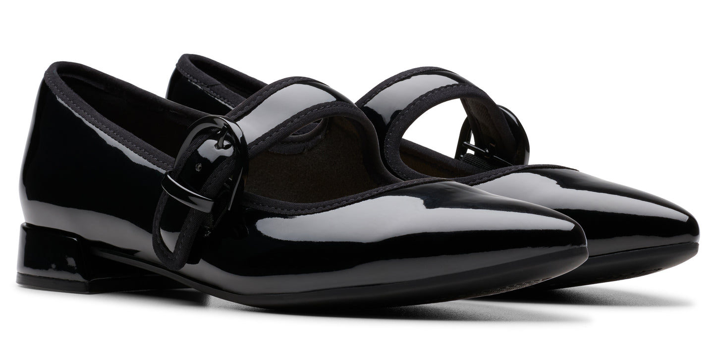 A pair of black patent leather Mary Jane shoes with a buckled strap.
