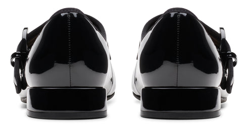 Back view of glossy black patent leather Mary Jane shoes with block heel and buckle.