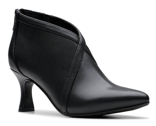 Black ankle boot with cone heel and overlapping leather straps.