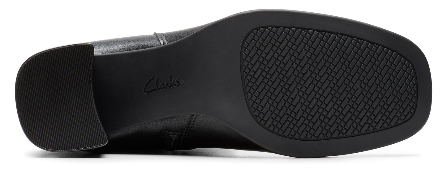The bottom of a black shoe with a textured sole.