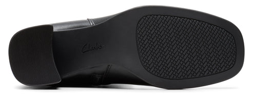 The bottom of a black shoe with a textured sole.