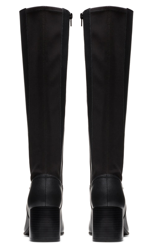 Pair of knee-high, black boots with a stacked block heel and a full length zipper at the back.
