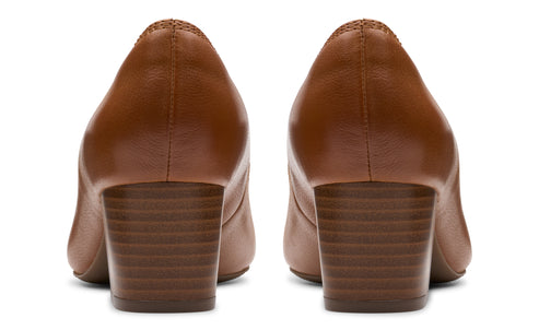 Rear view of two brown leather heeled dress shoes.