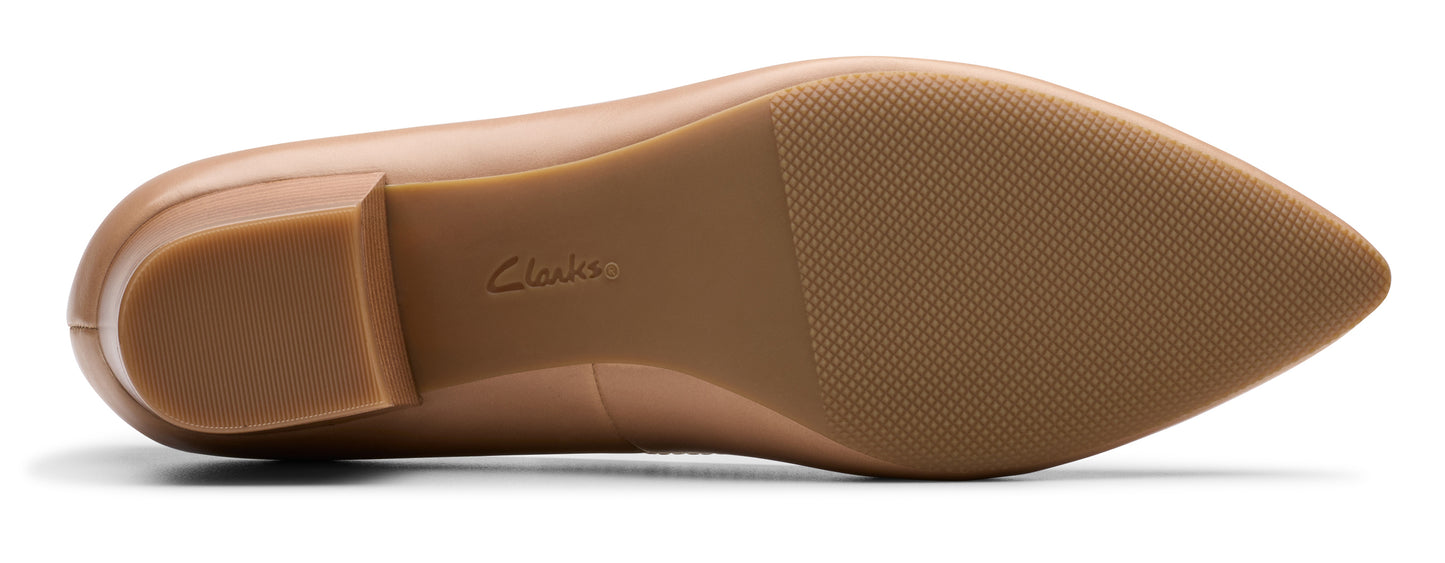 Bottom view of a pointed toe dress shoe.