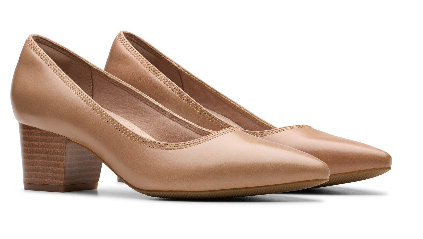 Pair of tan leather mid-heel pumps.