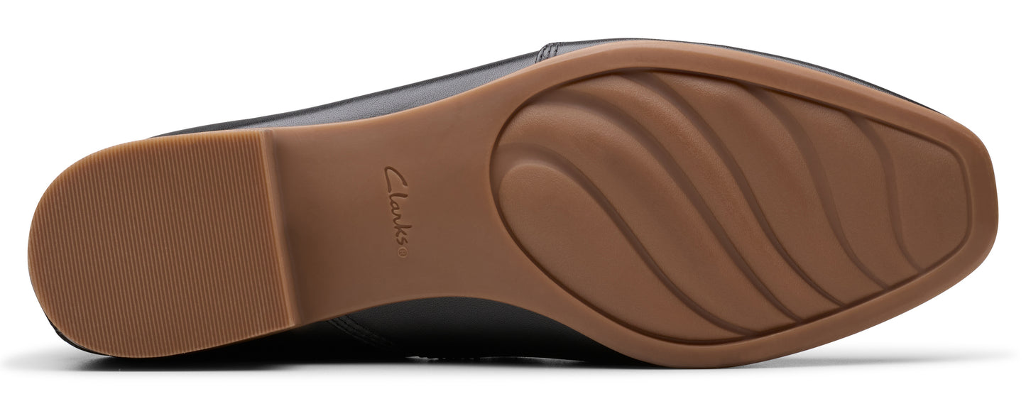 The sole of a shoe featuring a wavy traction pattern and the word "Clarks".
