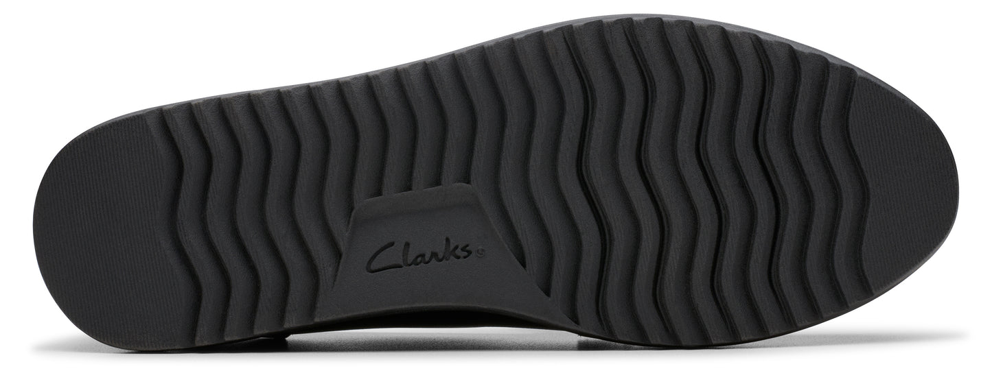 A black shoe sole with treads and the word "Clarks."