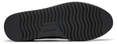 A black shoe sole with treads and the word "Clarks."
