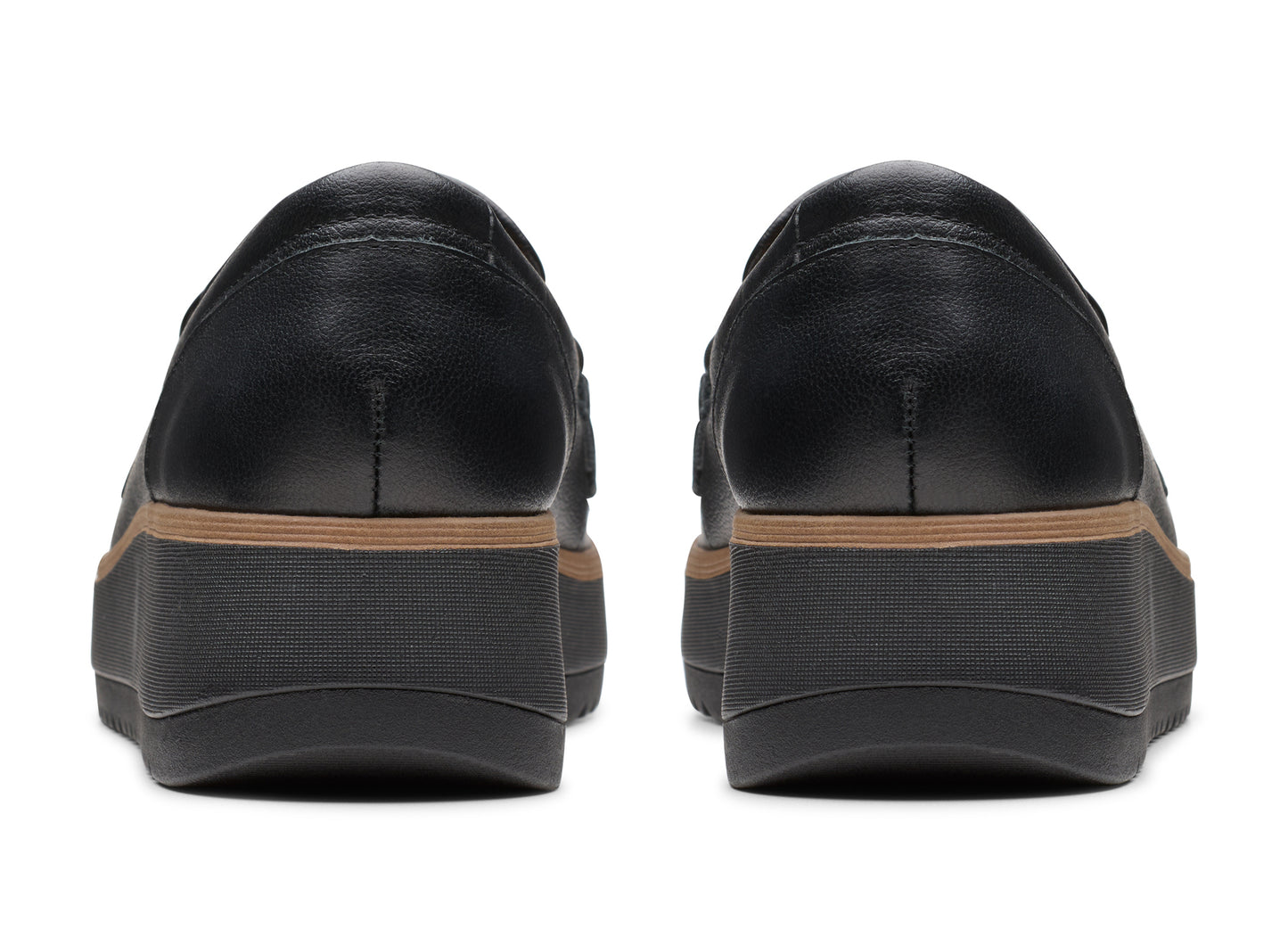 Two black leather loafers with a platform sole, rear view.