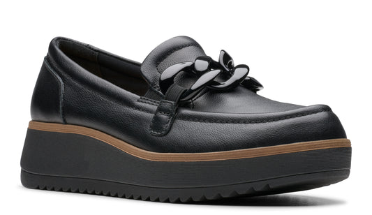 Black leather loafer with a black chain across the top and a thick black wedge sole.