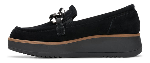 Black suede loafer-style shoe with silver chain and elevated sole.