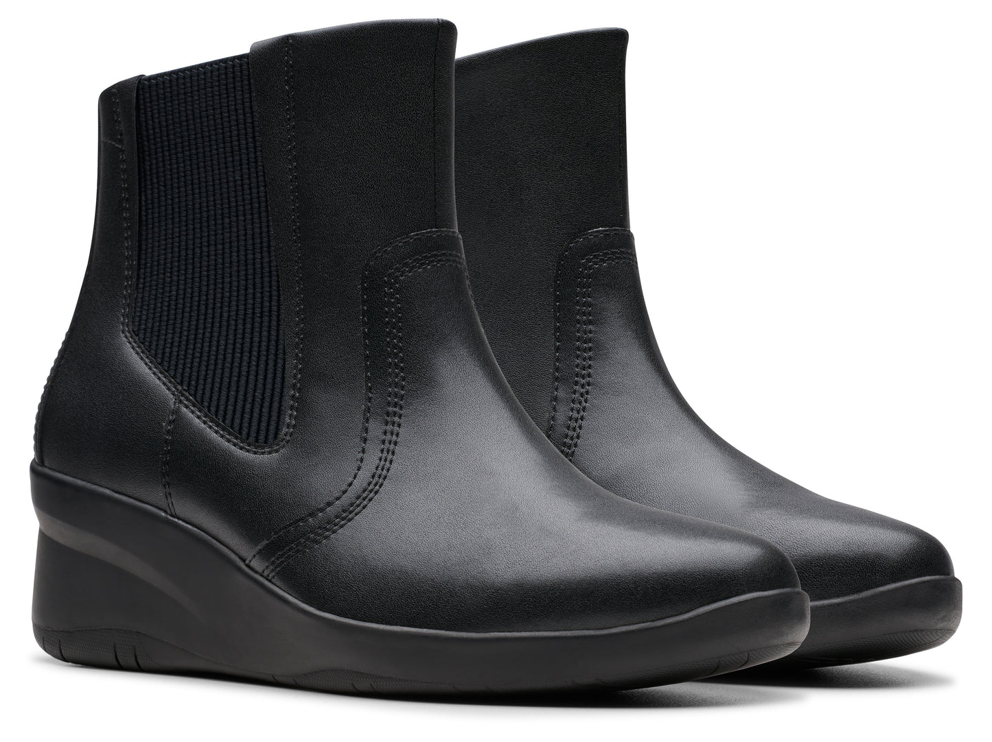 Pair of black wedge heel ankle boots with elastic side panels.