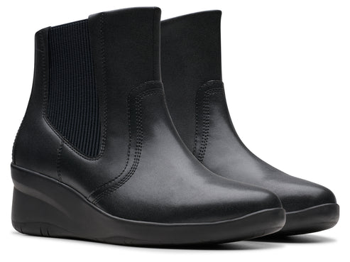 Pair of black wedge heel ankle boots with elastic side panels.