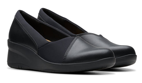 Pair of black wedge heel dress shoes with elastic instep panel.