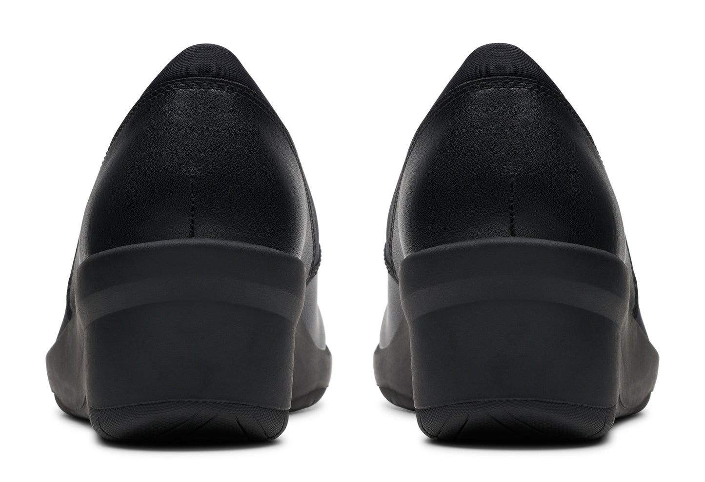 Pair of black leather wedge heel pumps from the back.