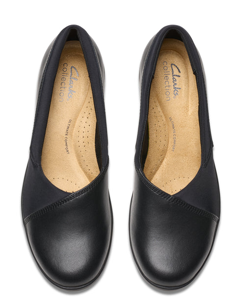 A pair of black leather ballet flats with a visible insole labeled 'Clarks collection ULTIMATE comfort'.