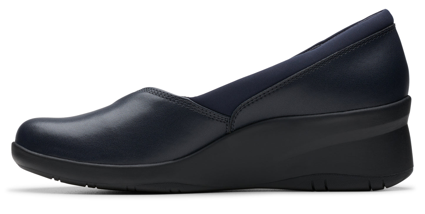 Navy blue wedge shoe with a rounded toe and soft fabric around the foot opening.