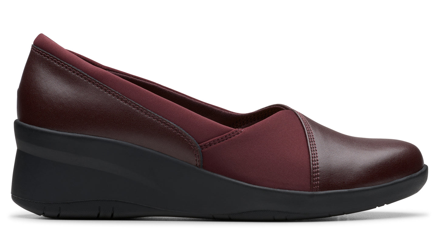 Burgundy wedge shoe with leather and elastic upper and low heel.