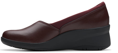 A slip-on shoe with a wedge heel in burgundy.