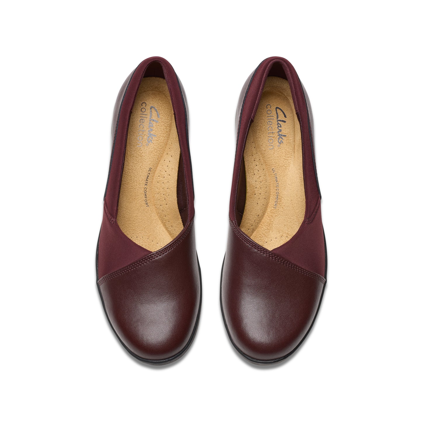 Pair of rounded-toe burgundy leather flats with fabric v-shaped panels.