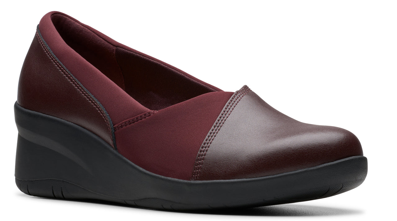 Maroon leather wedge shoe with a rounded toe and a low heel.