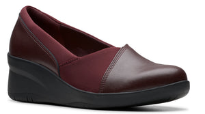 Maroon leather wedge shoe with a rounded toe and a low heel.