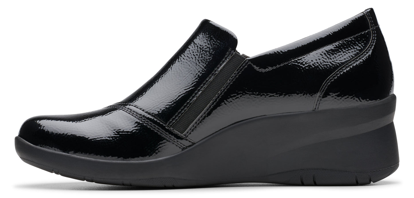 A shiny black loafer with a wedge heel.