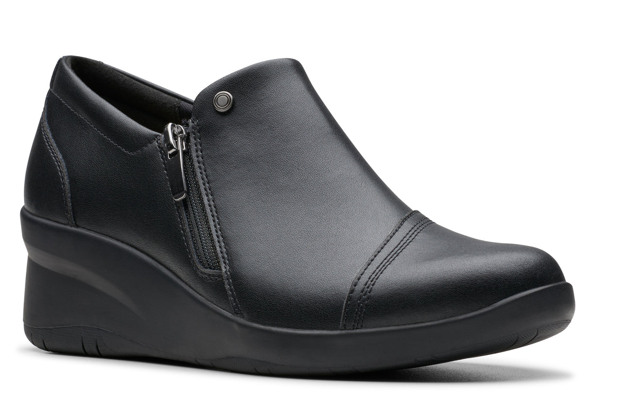 Black wedge slip-on shoe with a side zipper and rounded toe.