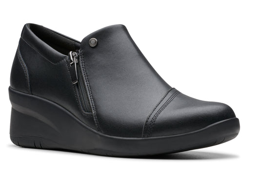Black wedge slip-on shoe with a side zipper and rounded toe.