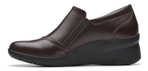 A brown slip-on shoe with a wedge heel.