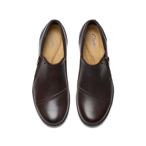 Pair of brown leather slip-on dress shoes, top view.