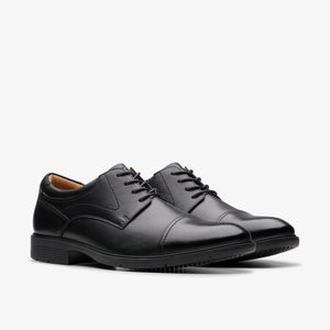 A pair of black leather cap toe dress shoes with black laces.