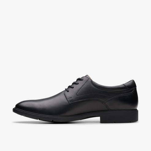 A black leather, lace-up dress shoe, seen in profile.