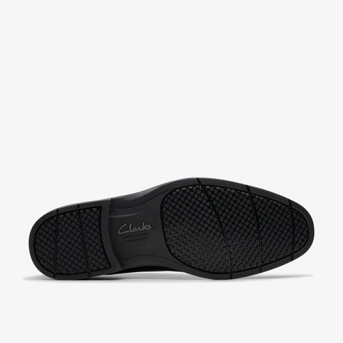 Black shoe sole with textured pattern and "Clarks" text.