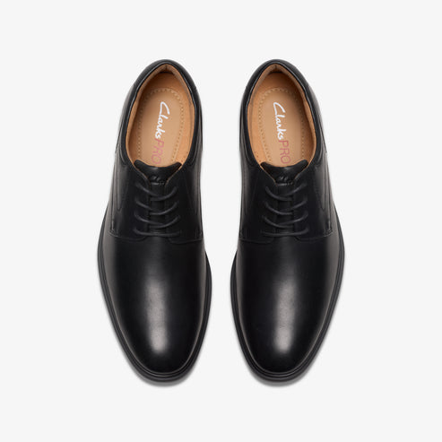 Pair of black leather dress shoes with laces.