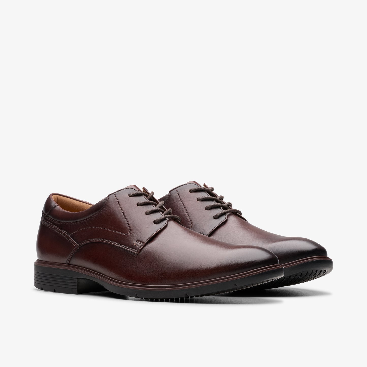 Pair of formal burgundy dress shoes with black laces and trim.