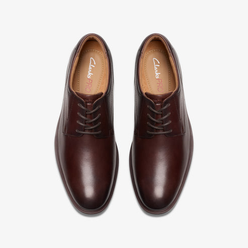Pair of brown leather dress shoes with laces.