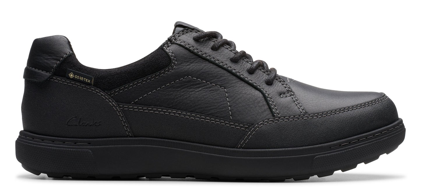 A dark gray, low-cut leather shoe with dark gray laces.