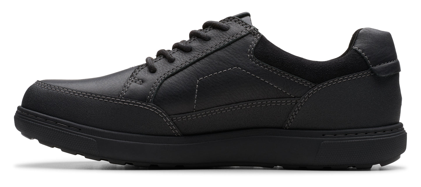 A black leather shoe with black laces.