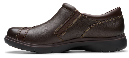 A brown leather slip-on shoe with a dark brown sole.