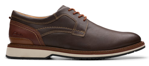 A brown leather dress shoe with brown laces and a white sole.
