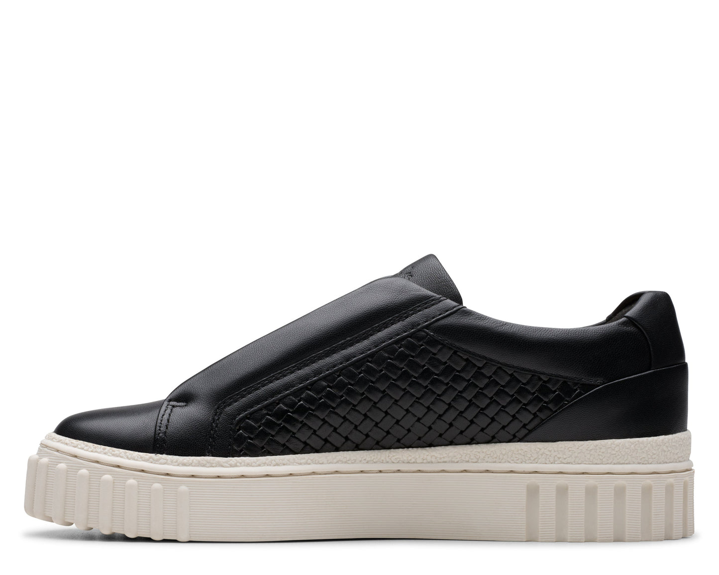 A black slip-on sneaker with a woven pattern on the side, and a thick white sole.