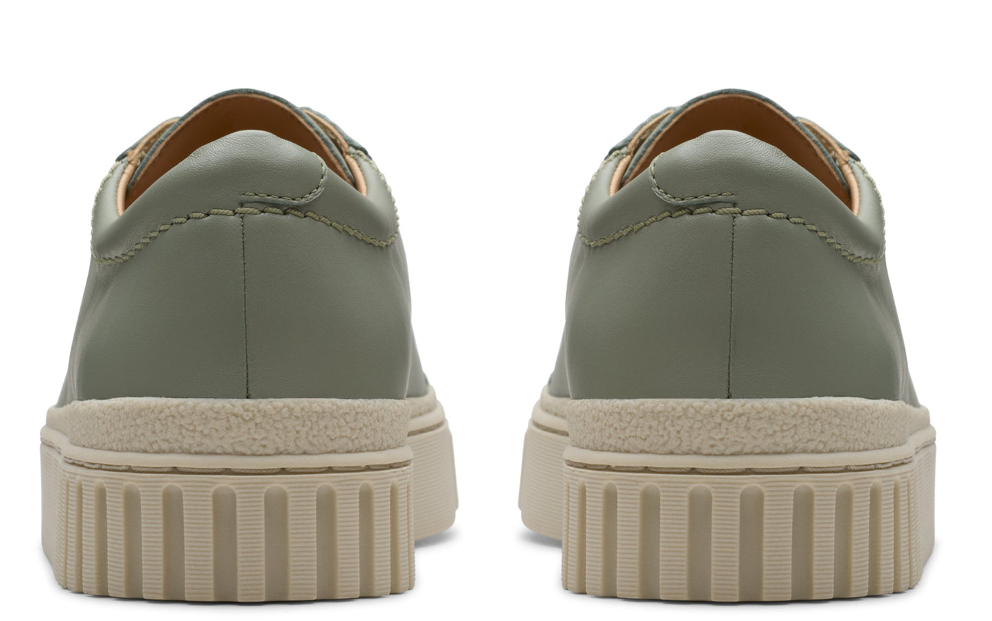 Back view of olive green leather sneakers with beige ribbed soles.