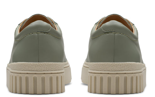 Back view of olive green leather sneakers with beige ribbed soles.