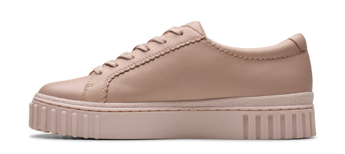 A light brown leather sneaker with a thick, ridged sole.