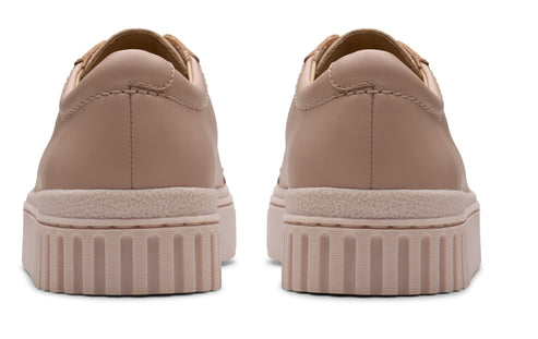 Pair of flat, pink sneakers with thick soles, rear view.