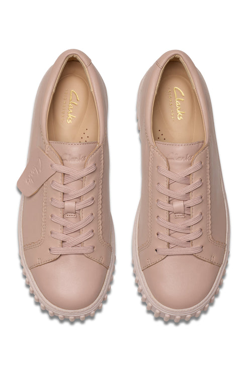 Two pink leather sneakers with light pink laces, soles with textured edges, and insole text stating "Clarks".