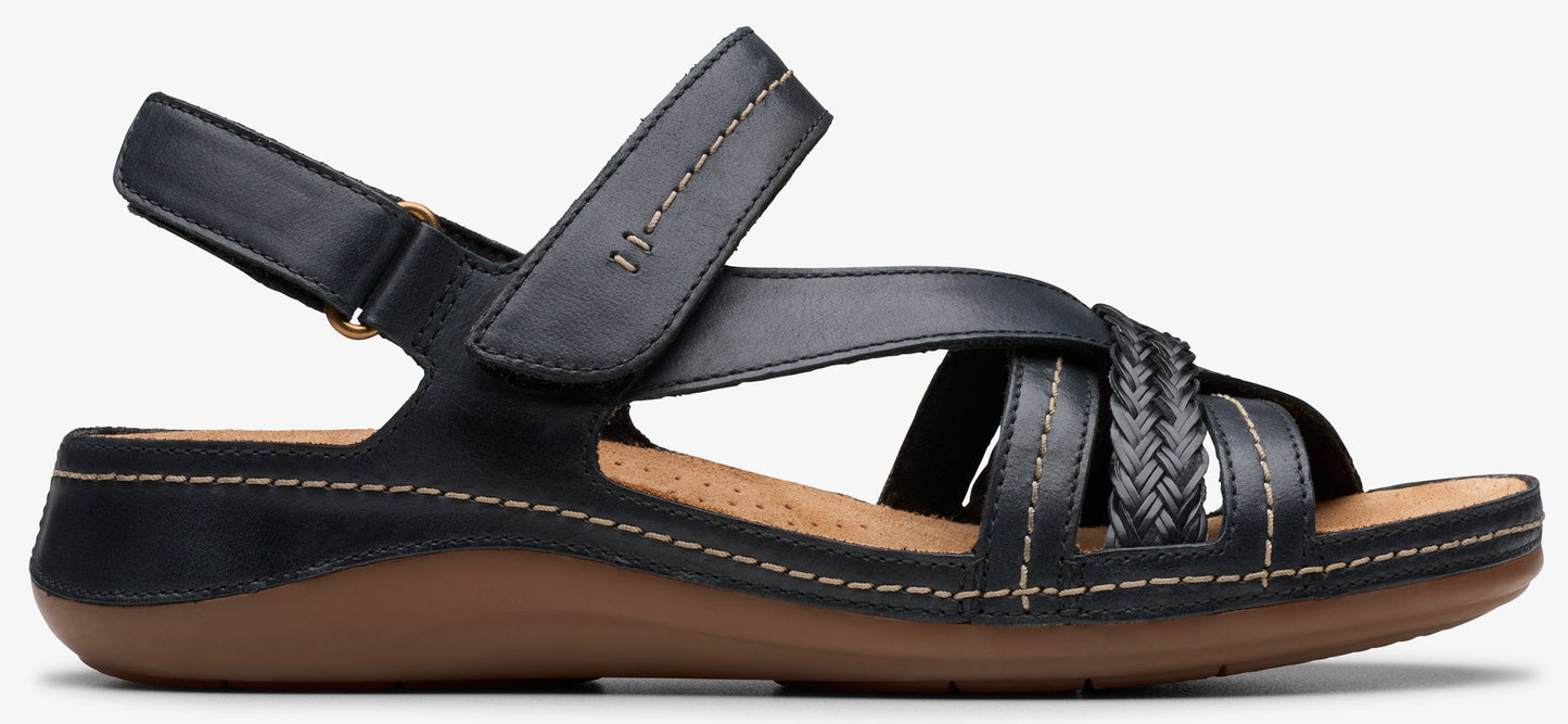 A black sandal with a brown sole and braided straps.
