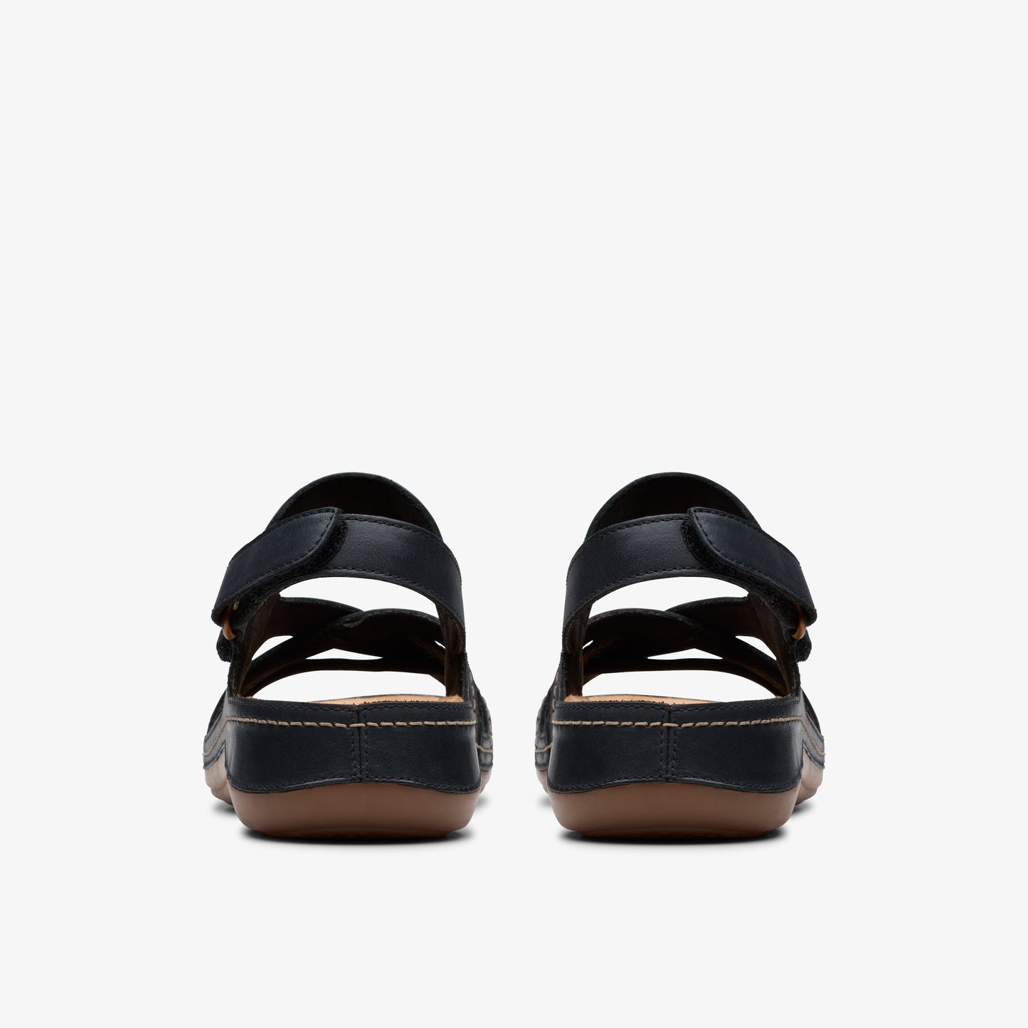 Back view of black comfort sandals with adjustable straps and brown soles.
