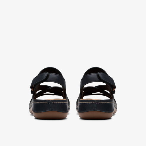 Back view of black comfort sandals with adjustable straps and brown soles.